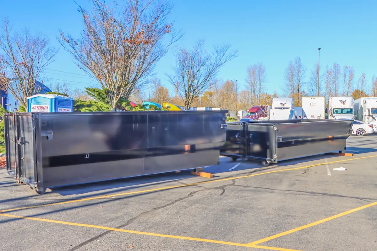 Professional dumpster rental service with roll-off container on residential driveway in Louisville